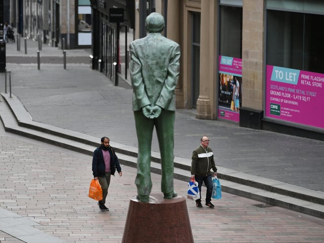 Donald Dewar watches over the near-empty Buchanan Street, Glasgow. Picture: John Devlin