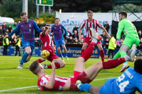 St Johnstone's Liam Gordon blocks a late chance for Inverness striker Billy McKay during the 2-2 draw in the Premiership play-off final 1st leg. (Photo by Ross Parker / SNS Group)