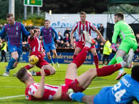 St Johnstone's Liam Gordon blocks a late chance for Inverness striker Billy McKay during the 2-2 draw in the Premiership play-off final 1st leg. (Photo by Ross Parker / SNS Group)