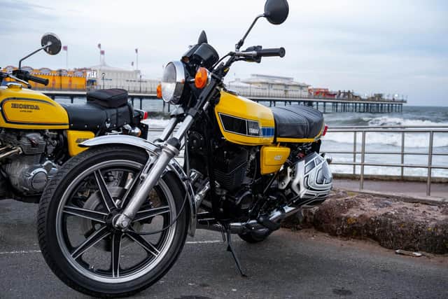 Motorbikes parked up on the seafront.
