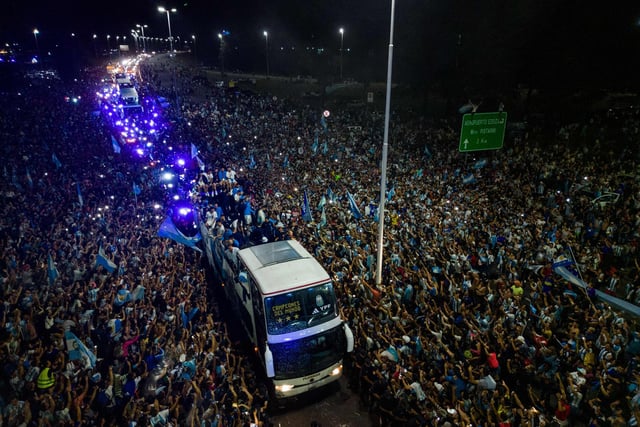 Argentina's players celebrating on board a bus with supporters after winning the Qatar 2022 World Cup tournament as they leave Ezeiza International Airport en route to the Argentine Football Association (AFA) training centre in Ezeiza, Buenos Aires province, Argentina.