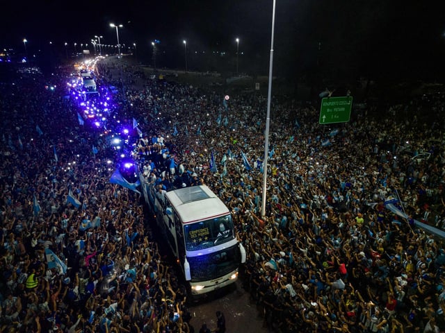 Argentina's players celebrating on board a bus with supporters after winning the Qatar 2022 World Cup tournament as they leave Ezeiza International Airport en route to the Argentine Football Association (AFA) training centre in Ezeiza, Buenos Aires province, Argentina.