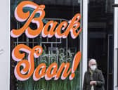 A shopper walks past a window display on Princes Street. Picture: Lisa Ferguson