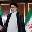 Russian President Vladimir Putin and Iran's President Ebrahim Raisi shake hands in Tehran in July last year (Picture: Sergei Savostyanov/Sputnik/AFP via Getty Images)