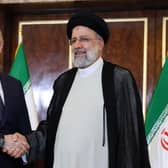 Russian President Vladimir Putin and Iran's President Ebrahim Raisi shake hands in Tehran in July last year (Picture: Sergei Savostyanov/Sputnik/AFP via Getty Images)