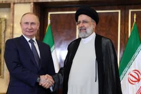 Russian President Vladimir Putin and Iran's President Ebrahim Raisi shake hands in Tehran in July last year (Picture: Sergei Savostyanov/Sputnik/AFP via Getty Images)