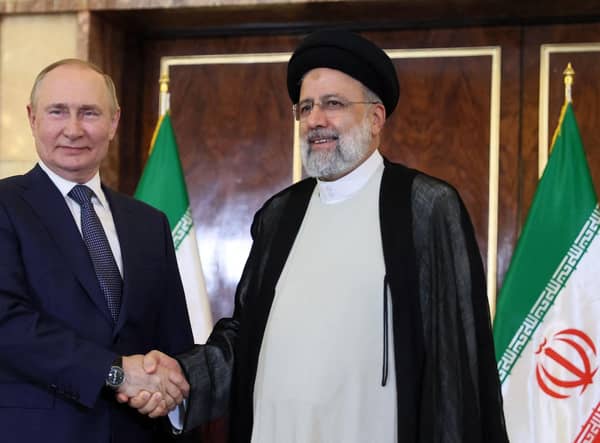 Russian President Vladimir Putin and Iran's President Ebrahim Raisi shake hands in Tehran in July last year (Picture: Sergei Savostyanov/Sputnik/AFP via Getty Images)