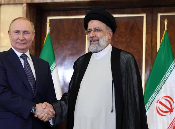 Russian President Vladimir Putin and Iran's President Ebrahim Raisi shake hands in Tehran in July last year (Picture: Sergei Savostyanov/Sputnik/AFP via Getty Images)