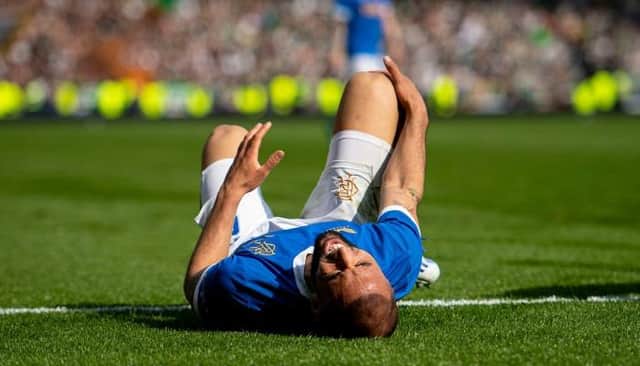 Rangers striker Kemar Roofe clutches his right knee in discomfort during last Sunday's Scottish Cup semi-final against Celtic at Hampden. (Photo by Ross MacDonald / SNS Group)