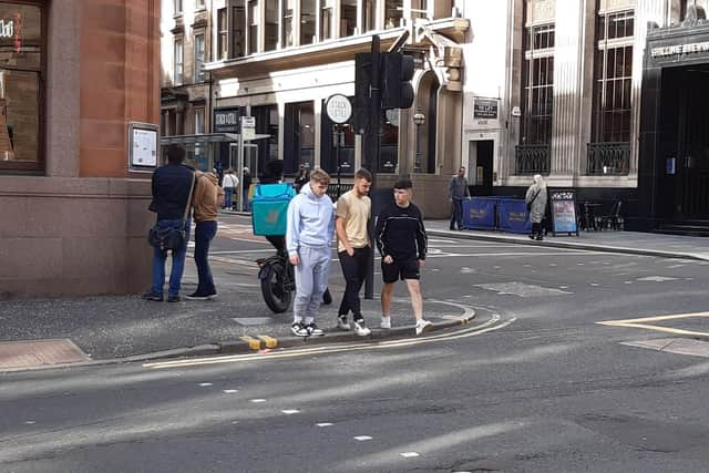 A delivery rider on the pavement in Glasgow. Picture: The Scotsman