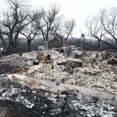 Adam Norris surveys the damage at his home near Drayton, Alberta, this week, after a wildfire swept through the area (Picture: Walter Tychnowicz/AFP via Getty Images)