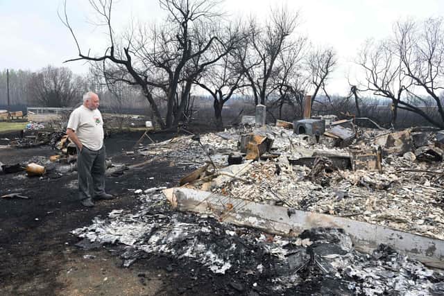 Adam Norris surveys the damage at his home near Drayton, Alberta, this week, after a wildfire swept through the area (Picture: Walter Tychnowicz/AFP via Getty Images)