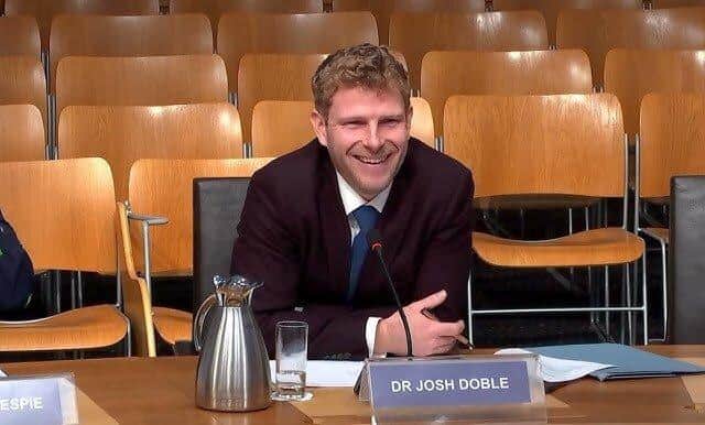 Dr Josh Doble addressing a meeting with MSPs in the parliament.