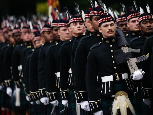 The Balaklava Company of the Argyll and Sutherland Highlanders arrive at the Palace of Holyrood House ahead of the hearse carrying the coffin of Queen Elizabeth II, draped with the Royal Standard of Scotland, as it completes its journey from Balmoral to Edinburgh, where it will lie in rest for a day. Picture date: Sunday September 11, 2022.