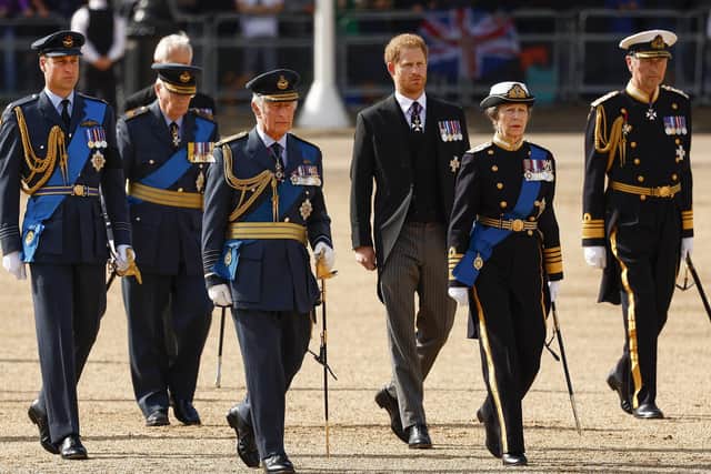 Prince William, Prince of Wales, Sir Timothy Laurence, Prince Harry, Duke of Sussex, King Charles III, Mr Peter Phillips, Anne, Princess Royal walk behind the coffin during the procession for the Lying-in State of Queen Elizabeth II