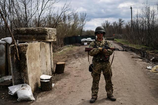 A Ukrainian serviceman stands guard at a checkpoint on the outskirts of Barvinkove, eastern Ukraine (Picture: Ronaldo Scheimdt / AFP/ Getty)