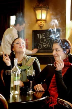 The last draw...smokers enjoy their final fags at an Edinburgh pub ahead of the smoking ban, which came in 15 years ago on March 26, 2006. PIC: Phil Wilkinson.
