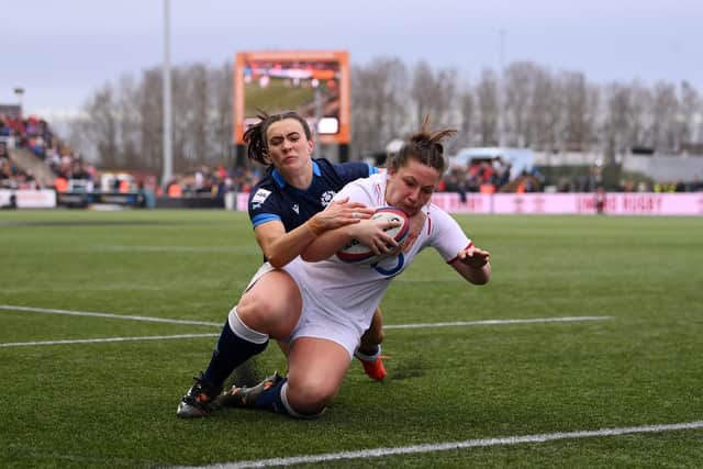 Amy Cokayne of England scores the side's second try under pressure from Francesca McGhie.