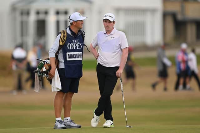 Bob MacIntyre talks to caddie Mike Thomson on the 17th green in the final round of the 150th Open at St Andrews. Picture: Ross Kinnaird/Getty Images.