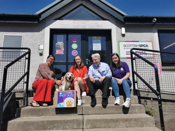 (L-R) Lynne Ogg, Scotmid communities manager, Sharon McSorley and Alan MacLeish, Scotmid regional committee members, Carrie Giannelli, Pet Aid co-ordinator and beagle Lily.