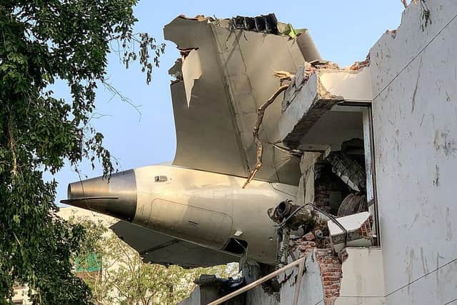 The back of Air India flight 171 is pictured at the site after it crashed in a residential area near the airport in Ahmedabad on June 12, 2025. A London-bound passenger plane crashed in the Indian city of Ahmedabad on June 12 and all 242 people on board were believed killed, with the jet smashing into buildings housing doctors and their families. (Photo by Sam PANTHAKY / AFP) (Photo by SAM PANTHAKY/AFP via Getty Images)