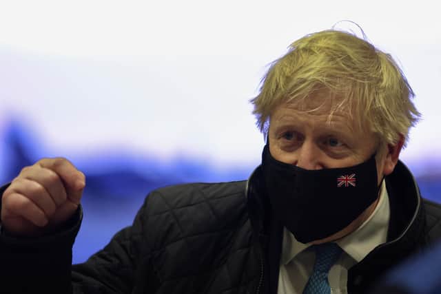 Prime Minister Boris Johnson wears a face mask during a visit to RAF Valley in Anglesey, North Wales. Picture date: Thursday January 27, 2022.