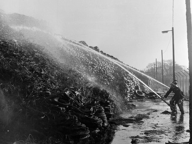 Firefighters spray water onto a pile of tyres that caught fire in the Edinburgh yard of the North British Rubber Company in April 1965.