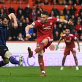 Aberdeen's Christian Ramirez shots as Hearts' Craig Halkett tries to block.
