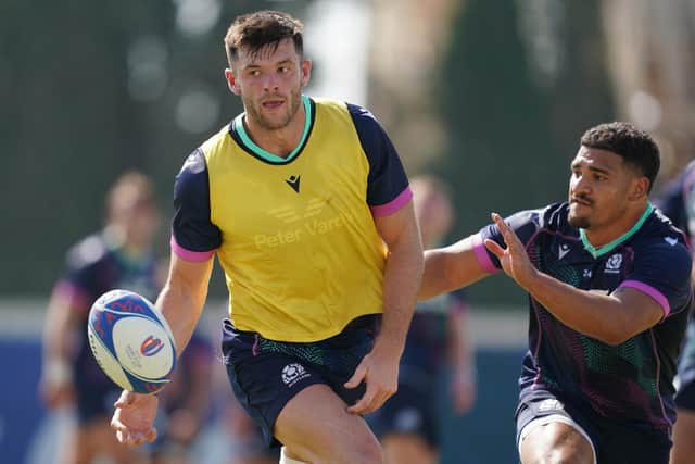 Blair Kinghorn offloads despite the close attention of Sione Tuipulotu during a Scotland training session ahead of the match against Tonga in Nice.  (Picture: David Davies/PA Wire)