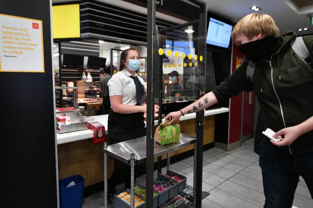 A customer collects a takeaway order in the Glasgow Trongate McDonald's branch.