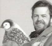 Nelson Norman meets a young penguin in Antarctica