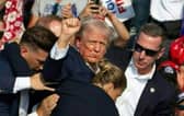 Republican candidate Donald Trump with blood on his face surrounded by secret service agents following an assassination attempt at a campaign event in Butler, Pennsylvania, July 13, 2024. PIC: Rebecca Droke /AFP/Getty Images