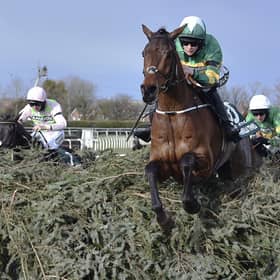 Rachael Blackmore riding Minella Times clears the last fence to win the Randox Grand National Handicap Chase in 2021. Photo: Peter Powell/Pool via AP, File.