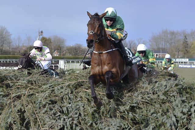 Rachael Blackmore riding Minella Times clears the last fence to win the Randox Grand National Handicap Chase in 2021. Photo: Peter Powell/Pool via AP, File.