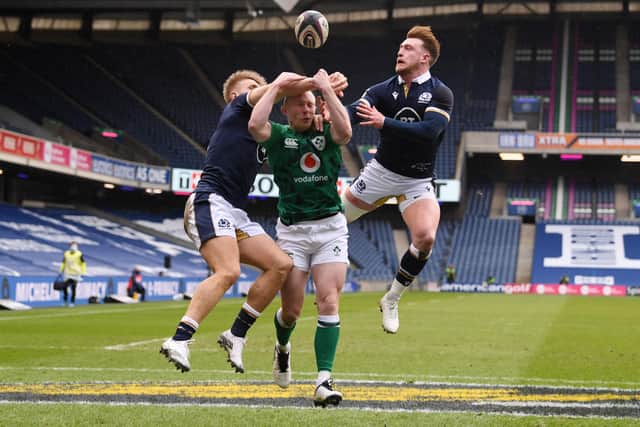 Keith Earls of Ireland competes for the ball with (L - R) Chris Harris and Stuart Hogg of Scotland leading to the first try scored by Robbie Henshaw (Not pictured) during the Guinness Six Nations match between Scotland and Ireland at Murrayfield on March 14, 2021 in Edinburgh, Scotland. Sporting stadiums around the UK remain under strict restrictions due to the Coronavirus Pandemic as Government social distancing laws prohibit fans inside venues resulting in games being played behind closed doors. (Photo by Stu Forster/Getty Images)