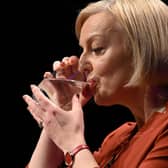 Liz Truss keeps a firm hold of her glass during her speech