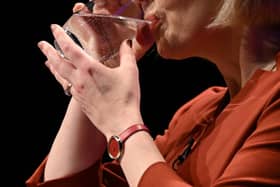 Liz Truss keeps a firm hold of her glass during her speech