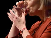 Liz Truss keeps a firm hold of her glass during her speech
