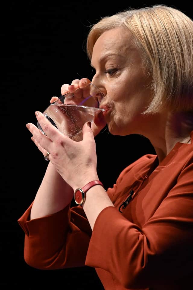 Liz Truss keeps a firm hold of her glass during her speech