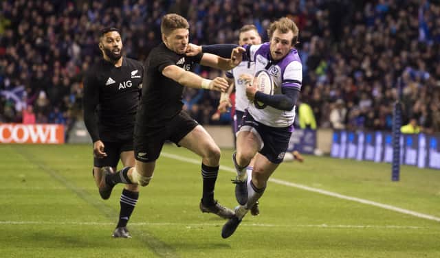 Scotland's Stuart Hogg (right) is tackled by the All Blacks' Beauden Barrett late in the 2017 Murrayfield game to be denied a try