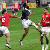 South African captain Lukhanyo Am grabs the ball ahead of Bundee Aki and Anthony Watson.
