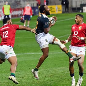 South African captain Lukhanyo Am grabs the ball ahead of Bundee Aki and Anthony Watson.