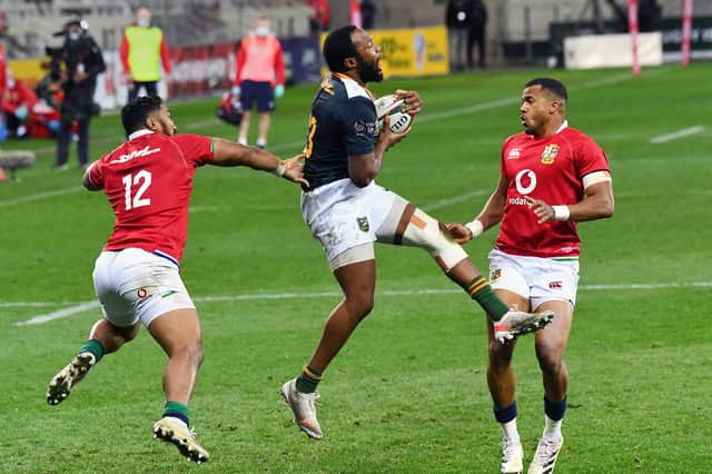 South African captain Lukhanyo Am grabs the ball ahead of Bundee Aki and Anthony Watson.