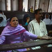 People mourn the deaths of those killed in a suicide bombing at the All Saints church in Peshawar in 2013 (Picture: A Majeed/AFP via Getty Images)