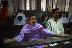 People mourn the deaths of those killed in a suicide bombing at the All Saints church in Peshawar in 2013 (Picture: A Majeed/AFP via Getty Images)