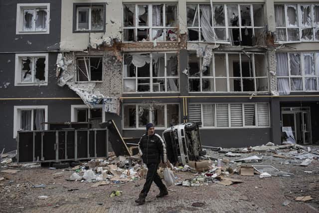 BUCHA, UKRAINE - APRIL 04: A man walks past a heavily damaged apartment building on April 4, 2022 in Bucha, Ukraine. The Ukrainian government has accused Russian forces of committing a "deliberate massacre" as they occupied and eventually retreated from Bucha, 25km northwest of Kyiv. (Photo by Alexey Furman/Getty Images)
