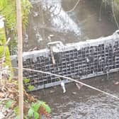 Pollution, in the form of items like wet wipes and sanitary products, in a Midlothian burn