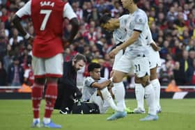Liverpool's Luis Diaz receives medical staff help after injuring against Arsenal on Sunday.