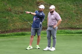 A stern-faced Tyrrell Hatton listens to his caddie Hugo Dodson during the first round of the Betfred British Masters hosted by Sir Nick Faldo at The Belfry. Picture: Luke Walker/Getty Images.