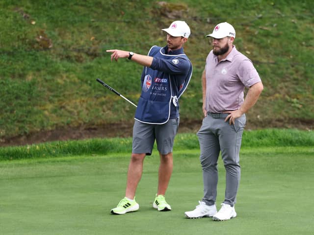 A stern-faced Tyrrell Hatton listens to his caddie Hugo Dodson during the first round of the Betfred British Masters hosted by Sir Nick Faldo at The Belfry. Picture: Luke Walker/Getty Images.